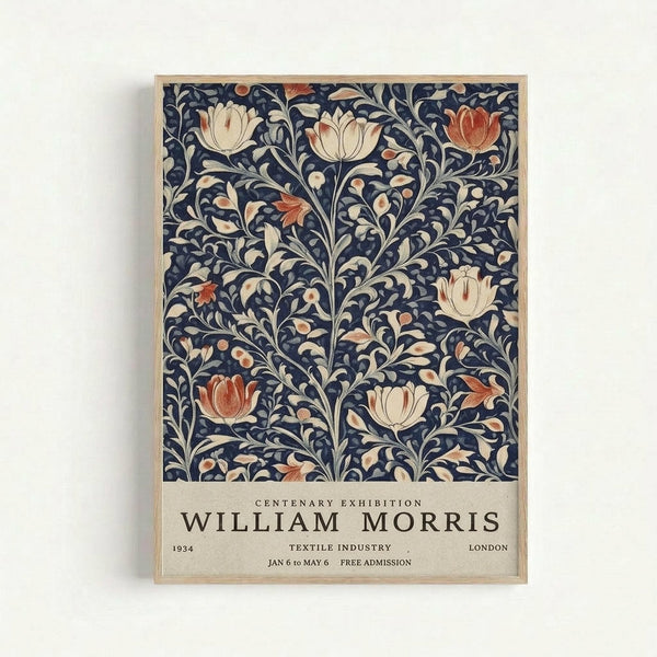 Framed vintage exhibition poster featuring William Morris floral textile pattern with cream and coral tulips on dark navy background with flowing botanical vines. White text at bottom reads "Centenary Exhibition William Morris" with exhibition details. Light wooden frame against white wall.