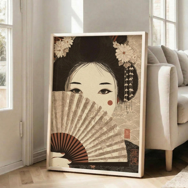 May include: Large framed poster leaning against white wall next to beige armchair in bright living room. Artwork shows Japanese woman with elaborate black hair adorned with flowers, holding decorative fan that partially covers her face. Muted earth tones with intricate wave patterns in background. Natural wood frame, approximately 3 feet tall.