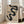 May include: A framed Bauhaus poster with flowing black curved shapes on beige textured background, featuring "Form Follows Function" text and exhibition details from Weimar 1919. The light wood frame leans against white walls next to a beige upholstered sofa in a bright, minimalist living room with large windows.