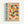 Framed poster with geometric Bauhaus-style design featuring colorful semicircles and quarter-circles in orange, blue, red, and yellow arranged in a grid pattern. Bold blue text reads "BAUHAUS" vertically on left side with red "MODERN ART" text. German text appears at top and bottom describing the Weimar art school from 1919-1933. Natural wood frame against white wall.