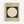 Framed vintage-style poster with beige background featuring "BAUHAUS 1919" text at top. Central design shows large cream circle on dark green square. German text below describes the Bauhaus school from 1919-1933. Light wood frame displayed against white wall with subtle shadow.