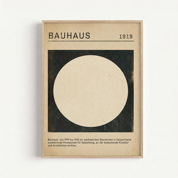 Framed vintage-style poster with beige background featuring "BAUHAUS 1919" text at top. Central design shows large cream circle on dark green square. German text below describes the Bauhaus school from 1919-1933. Light wood frame displayed against white wall with subtle shadow.