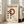 May include: Framed Bauhaus-style poster with cream background featuring red circle and black dots in geometric arrangement, displayed against white wall next to beige sofa in bright living room with large windows and natural light streaming across wooden floor