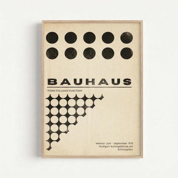Framed poster with cream background featuring ten black circles arranged in two rows at top, bold black "BAUHAUS" text with underline, "FORM FOLLOWS FUNCTION" subtitle in quotes, geometric pattern of white circles on black triangular shape, and German text at bottom indicating Weimar Juni-September 1919 Stuttgart kunstgebäude am Schlossplatz, displayed against white wall