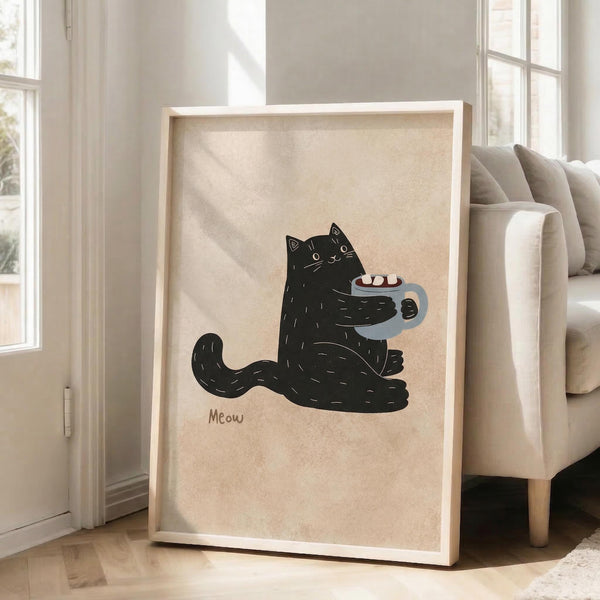 May include: Framed poster print featuring a black cat holding a gray mug with marshmallows, illustrated in simple line art style with "Meow" text below, displayed in light wood frame leaning against white wall next to beige upholstered chair in bright, sunlit room with large windows.