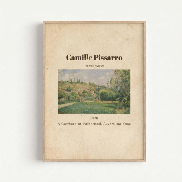 May include: Framed art print mounted on white wall showing Camille Pissarro's 1874 impressionist landscape painting. Features rolling green countryside with trees, hills, and pastoral scene in soft greens and earth tones. Text identifies artist, museum, date, and artwork title on cream-colored background within light wood frame.
