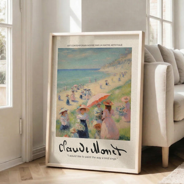 May include: Framed art print featuring Claude Monet's impressionist beach scene with figures in period dress enjoying a sunny coastal day, displaying soft blues, greens, and coral tones. The print shows Monet's signature and an inspirational quote, mounted in a light wooden frame leaning against a beige sofa in a bright, minimalist living room with white walls and natural lighting from tall windows.