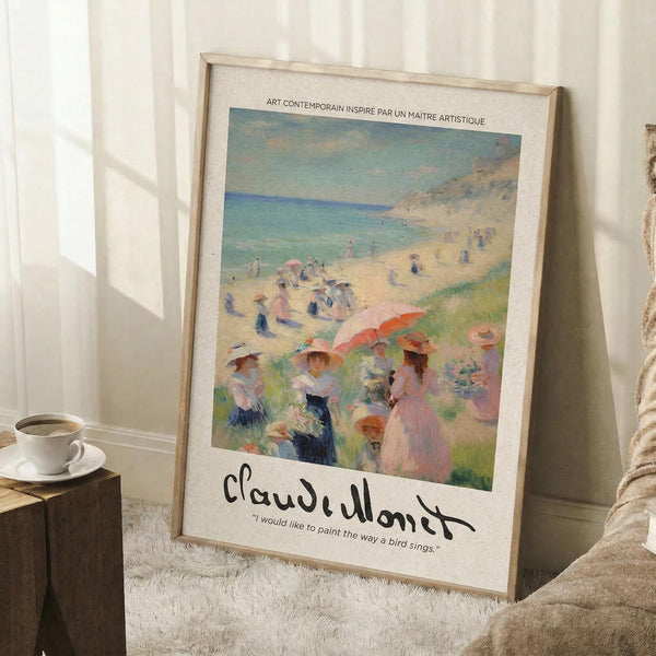 May include: Framed art print leaning against white wall on fluffy white rug next to wooden side table with teacup and beige throw blanket. Print shows impressionist beach scene with people in period dress holding colorful parasols on sandy coastline with turquoise water. Features Claude Monet signature and quote below artwork in cream matted frame.