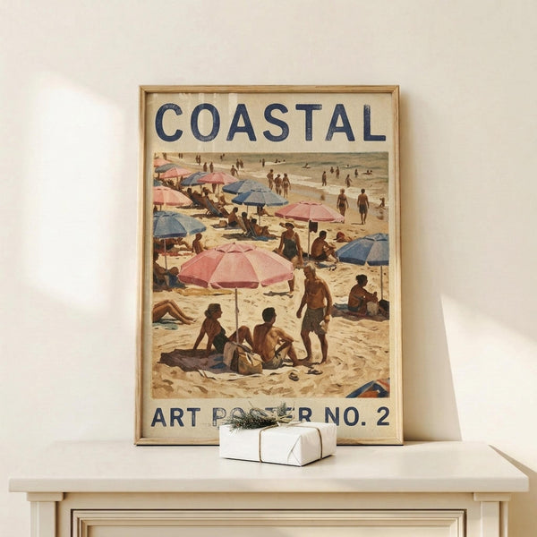 May include: Framed vintage-style beach scene poster with "COASTAL" and "ART POSTER NO. 2" text, showing people with colorful umbrellas on sandy beach. Natural wood frame, displayed on light wood surface with small white wrapped gift. Warm tones with pink and blue beach umbrellas, retro illustration style reminiscent of mid-century travel posters.
