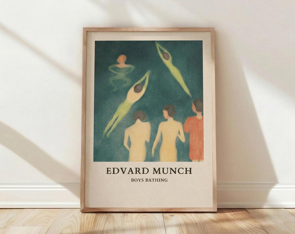 May include: Framed art print leaning against white wall on light wood floor with natural window light casting shadows. The poster features Edvard Munch's expressionist painting showing figures bathing in teal-green water - pale yellow nude forms and one figure in orange, with elongated swimmers above. Light wood frame with cream matting surrounds the artwork in this minimalist room setting.