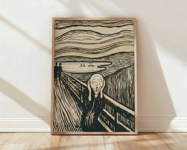 May include: Framed print of The Scream artwork leaning against white wall on light wood floor. Black and white lithograph style showing distorted figure with hands to face on wooden bridge, two silhouettes in background, wavy sky lines above water with boats. Natural wood frame, dramatic shadows cast across white wall and floor.