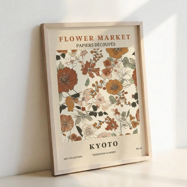 May include: Framed botanical poster with vintage-style floral illustrations in warm earth tones including rust, orange, and sage green flowers and leaves against cream background, displayed in light wood frame leaning against white wall with soft natural lighting
