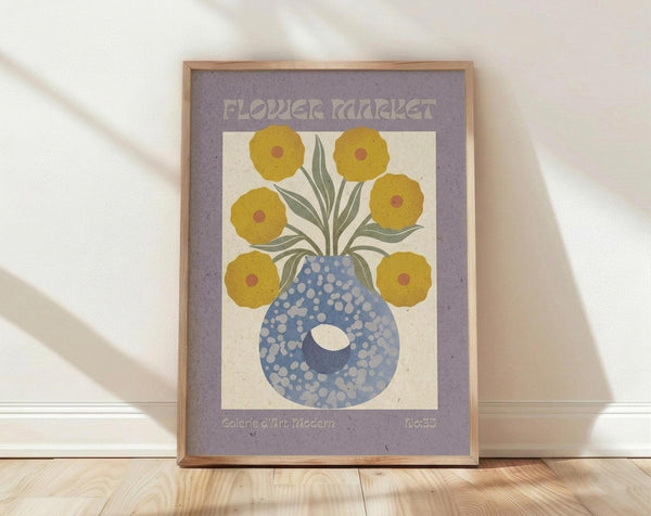 May include: Framed vintage-style poster print featuring six golden yellow flowers with burgundy centers in a blue polka-dotted vase, displayed against a white wall on light wood flooring. The artwork has a purple border with "FLOWER MARKET" text at top and gallery information at bottom, shown in natural lighting with soft shadows.