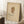 May include: Framed botanical print featuring a detailed sea fan coral illustration in earthy tones of brown, green and rust on textured cream paper. The vintage-style scientific artwork shows delicate branching coral structure with small detail studies below. Light wooden frame leans against white paneled wall next to cozy beige blanket and wooden side table with white coffee cup, creating a serene natural home decor scene with soft window lighting.