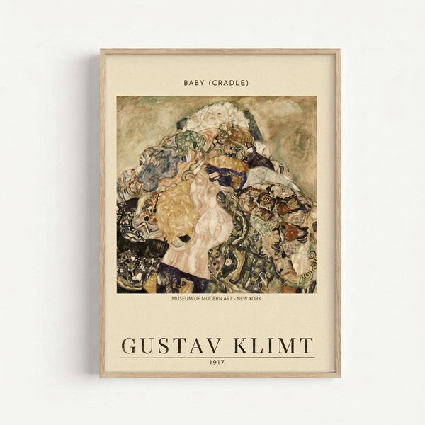 May include: Framed art print displayed on white wall showing Gustav Klimt's 1917 painting "Baby (Cradle)" - an expressionist artwork depicting swirling figures and infants in earth tones of brown, green, and cream. The museum-style poster has cream matting with black text identifying the artwork, artist name, year, and Museum of Modern Art New York. Light wood frame against minimal white background.