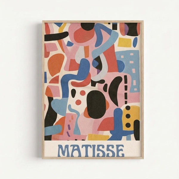 A colorful abstract art poster in a light wood frame mounted on a white wall. The artwork features organic shapes and geometric forms in vibrant blues, coral pinks, oranges, yellows, and black arranged in a playful, modernist composition. The word "MATISSE" appears in blue letters at the bottom of the print. The design includes curved lines, circles, rectangles, and flowing abstract forms that overlap and interweave throughout the composition.