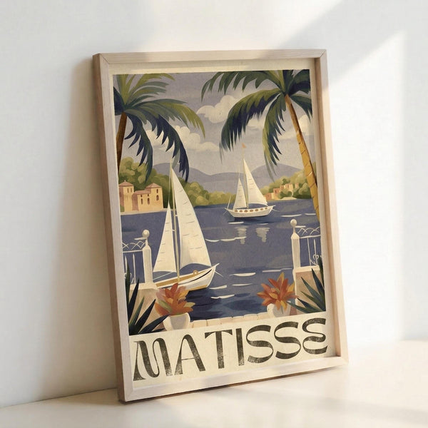 Framed vintage-style travel poster showing a Mediterranean coastal scene with sailboats on blue water, palm trees, peachy buildings, and decorative balustrades. The artwork features muted colors in a mid-century illustration style with "MATISSE" text at bottom. Light wood frame sits against white wall, casting soft shadows.