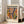 May include: Framed Matisse exhibition poster with colorful abstract cut-out shapes in orange, purple, yellow, and green, displayed against white wall next to beige sofa in bright living room with large windows and natural lighting.