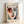 May include: Framed art print featuring an abstract portrait in Matisse's style with bold brushstrokes, showing a face with one red eye area, one blue side, dark eyebrows, and red lips against a cream background. The print displays "HENRI MATISSE" at the top with French text and an inspirational quote at the bottom. Light wooden frame leaning against white wall with natural lighting creating soft shadows.