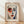 May include: Framed poster featuring a stylized portrait in Matisse-inspired style with bold colors - red and blue face tones, black eyebrows, red lips, against cream background. Text reads "HENRI MATISSE" at top with French subtitle and quote below. Natural wood frame sits on light wooden floor against white wall with soft window light shadows.