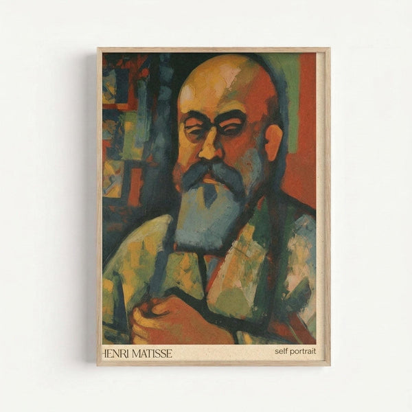 Framed art print featuring a colorful expressionist self-portrait of a bald man with a mustache and beard, painted in vibrant oranges, greens, and blues. The artwork shows bold brushstrokes and geometric color blocking typical of early 20th century modern art. The piece is displayed in a simple light wood frame against a white wall, with text at the bottom identifying it as a Henri Matisse self-portrait.