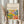 May include: Hands holding a framed art poster featuring a vibrant Matisse-style landscape with colorful trees, foliage in greens, yellows, blues, and oranges against a cream background. Light wood frame, dried pampas grass visible to the left, soft natural lighting near white curtained window.