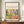 May include: Framed art poster featuring vibrant Matisse-style botanical artwork with colorful trees, foliage and abstract shapes in yellow, green, purple and orange tones. Text reads "Discover the Beauty of Matisse's Art" and "Modern Home Decor." Brown wooden frame displayed on walnut credenza beside white ceramic vase and stacked books in elegant room with cream walls and white molding.