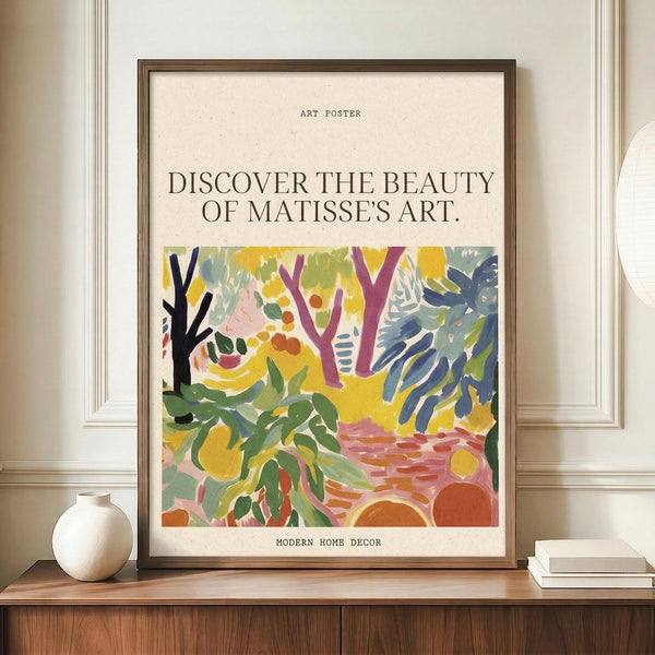 May include: Framed art poster featuring vibrant Matisse-style botanical artwork with colorful trees, foliage and abstract shapes in yellow, green, purple and orange tones. Text reads "Discover the Beauty of Matisse's Art" and "Modern Home Decor." Brown wooden frame displayed on walnut credenza beside white ceramic vase and stacked books in elegant room with cream walls and white molding.
