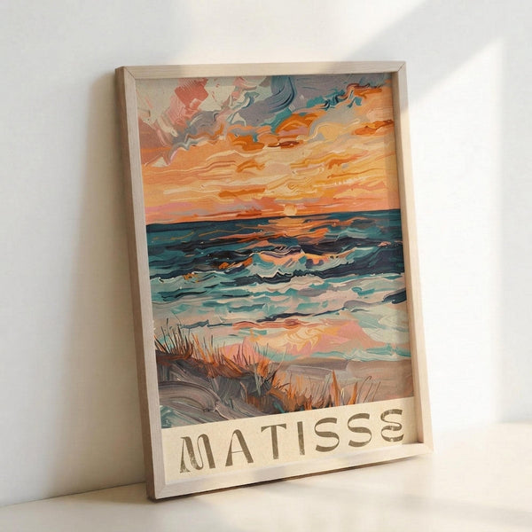 May include: Framed art print featuring a vibrant seascape painting in an impressionist style, displayed in a light wooden frame leaning against a white wall. The artwork shows rolling ocean waves in blues and teals, with a dramatic sunset sky in warm oranges and corals above. Beach grass appears in the foreground, and "MATISSE" text is printed at the bottom of the piece.