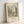 May include: Framed vintage-style art print featuring a sepia-toned landscape drawing with trees, a river, and parkland scenery. The print shows museum exhibition text including dates 1885-1890 and The Art Institute of Chicago attribution to Henri Rousseau. Light wood frame sits against white wall on white surface with soft natural lighting.