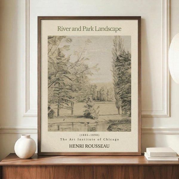 May include: Framed vintage-style poster displaying a sepia-toned pencil sketch of a peaceful riverside scene with trees, small buildings, and water reflections. The artwork features "River and Park Landscape" title, dates (1885-1890), "The Art Institute of Chicago" and "HENRI ROUSSEAU" text below the illustration. Displayed on a warm wood credenza with white ceramic vase and stacked books against cream walls with white trim molding.