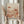 May include: Person holding framed abstract art print featuring warm terracotta and cream colored organic shapes, dots, and botanical elements including mushrooms and fan-like forms. Light wood frame against neutral curtained background with dried pampas grass visible on left side. Soft natural lighting creates calm, minimalist styling.