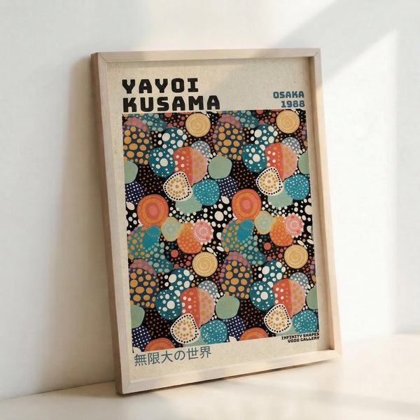 A framed art print featuring Yayoi Kusama's signature polka dot style with overlapping circles in vibrant colors including orange, teal, coral, yellow, and navy against a black background. The poster displays "YAYOI KUSAMA" at the top, "OSAKA 1988" in the upper right, and Japanese text at the bottom. The print is displayed in a light wood frame leaning against a white wall, showing the colorful dotted pattern that creates an infinite, mesmerizing visual effect.
