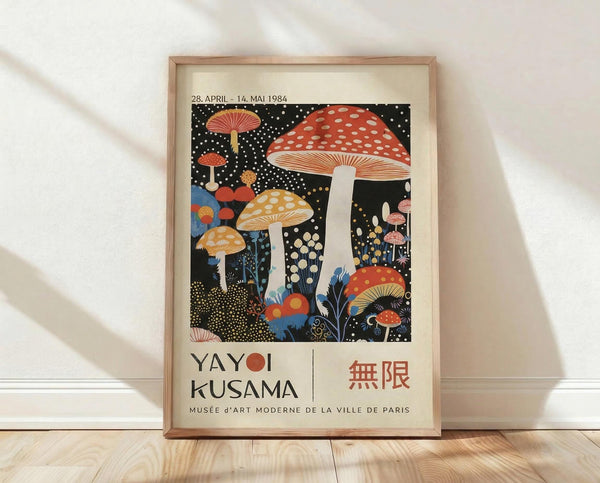 May include: A framed art print featuring colorful mushrooms on a black starry background, displayed against a white textured wall on light wooden flooring. The poster shows red spotted toadstools, yellow mushrooms, and various fungi in vibrant colors with polka dot patterns scattered throughout. Text at bottom reads "YAYOI KUSAMA" with Japanese characters and "MUSÉE d'ART MODERNE DE LA VILLE DE PARIS" along with exhibition dates.