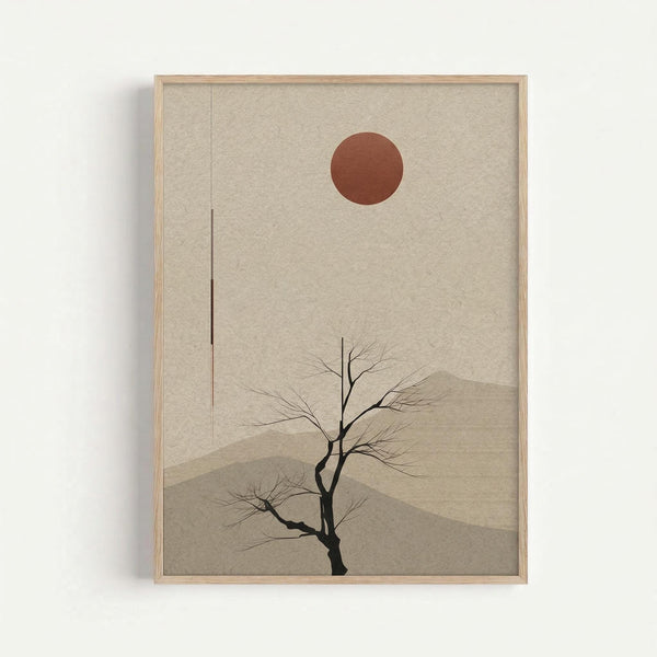 A minimalist artwork in a light wood frame showing a bare black tree silhouette against layered beige and tan mountain shapes, with a rust-colored circular sun in the upper portion. The piece has muted earth tones and clean geometric forms, displayed on a white wall with subtle shadowing around the frame edges.