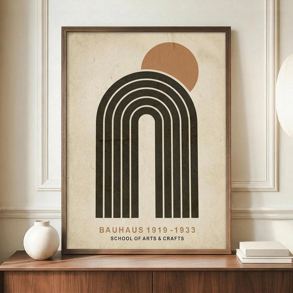 May include: Framed minimalist poster featuring a large dark green rainbow arch with cream stripes and a terracotta sun circle above, displayed on wooden sideboard next to white ceramic vase and books in neutral-toned room with paneled walls