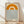 May include: Minimalist poster in light wood frame leaning against white wall on wooden floor. Features large orange semi-circle sun design above blue wavy lines representing water on cream background. Text reads "bauhaus 1919" in simple black lowercase letters. Natural lighting creates soft shadows on white textured wall.