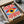 May include: Framed abstract eye artwork with radiating red and white stripes, yellow iris, dark blue pupil, and blue geometric accents, displayed in black frame inside cardboard shipping box with protective tissue paper packaging