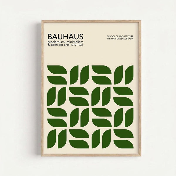 A framed poster with cream background featuring bold green geometric shapes arranged in a 4x4 grid pattern. The shapes are curved segments that create a repeating modular design. At the top, black text reads "BAUHAUS" with subtitle "Modernism, minimalism & abstract arts 1919-1933" and "SCHOOL OF ARCHITECTURE WEIMAR, DESSAU, BERLIN" in the upper right. The poster is displayed in a light wood frame against a white wall.