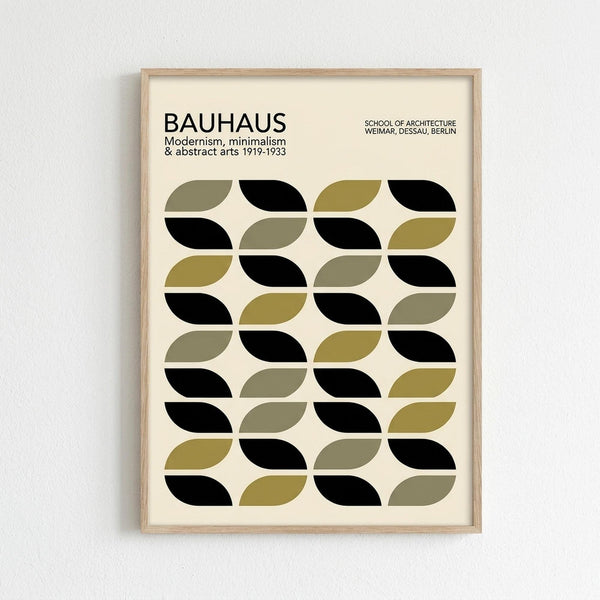 Framed poster with cream background featuring geometric pattern of alternating black, olive green, and sage green leaf-like shapes arranged in rows. Text at top reads "BAUHAUS Modernism, minimalism & abstract arts 1919-1933" and "SCHOOL OF ARCHITECTURE WEIMAR, DESSAU, BERLIN". Light wood frame hangs on white textured wall, casting subtle shadow.