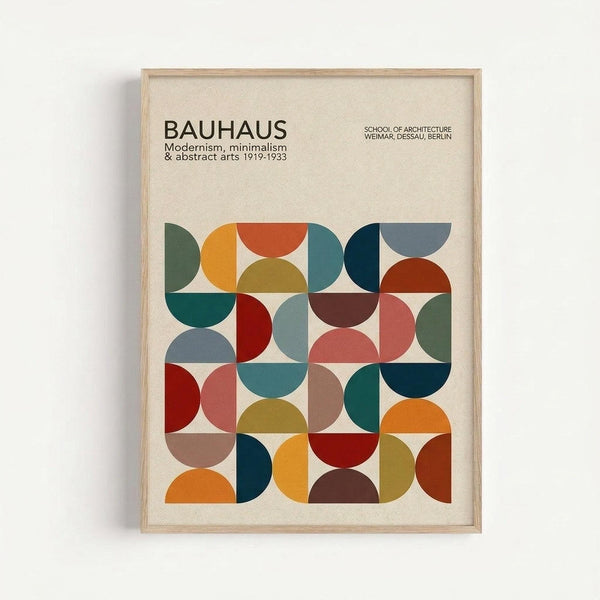 Framed minimalist geometric poster with colorful semicircles and quarter-circles in a grid pattern. Features earthy tones including orange, teal, red, olive green, and brown shapes on cream background. Text reads "BAUHAUS" with "Modernism, minimalism & abstract arts 1919-1933" and "School of Architecture Weimar, Dessau, Berlin." Light wood frame displayed on white wall with subtle shadow.