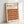 May include: Framed Bauhaus-inspired poster with geometric pattern of overlapping circles in warm autumn colors including orange, burgundy, brown, and rust tones arranged in rows. Text reads "BAUHAUS Modernism, minimalism & abstract arts 1919-1933" and "School of Architecture Weimar, Dessau, Berlin." Light wood frame against white wall with soft shadow cast to the right.