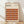 May include: Framed Bauhaus poster with geometric pattern of overlapping circles in warm autumn colors - oranges, browns, burgundy, and rust tones arranged in rows. The minimalist design features text about the German art school from 1919-1933. Natural wood frame sits against white wall on light wooden floor with soft shadows from window light.