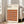 May include: Framed Bauhaus poster with geometric pattern of overlapping circles in warm autumn colors - oranges, browns, and burgundy - leaning against white wall next to beige upholstered chair in bright, minimally decorated room with large windows and natural light streaming across wooden floors.