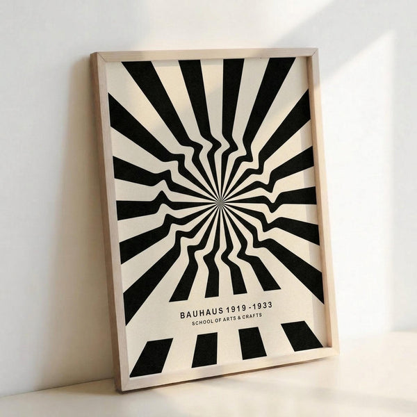 May include: Black and white optical illusion poster with radiating stripes creating a warped tunnel effect, displayed in light wooden frame against white wall. The design features alternating black and cream stripes emanating from center point with wavy distortion in middle section. Text reads "BAUHAUS 1919-1933 SCHOOL OF ARTS & CRAFTS" at bottom. Frame appears medium-sized and leans against wall surface.