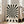May include: Black and white geometric poster with radiating sunburst pattern creating an optical illusion effect, displayed in light wood frame leaning against white wall next to beige upholstered sofa. The design features bold alternating stripes emanating from center point with wavy distortion. Text at bottom reads "BAUHAUS 1919-1933 SCHOOL OF ARTS & CRAFTS" in simple black lettering on cream background.