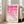 May include: A framed geometric art print with pink circular and semi-circular shapes arranged in a grid pattern on cream background, displayed in light wood frame leaning against white wall next to beige upholstered sofa in bright, naturally-lit room with large windows and hardwood floors.