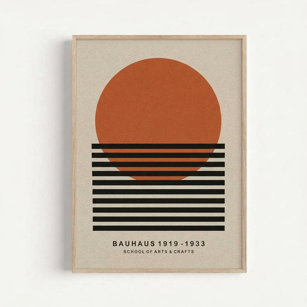 Minimalist geometric poster featuring a large orange circle above horizontal black and white stripes on cream background. Text reads "BAUHAUS 1919-1933 SCHOOL OF ARTS & CRAFTS" at bottom. Displayed in light wood frame against white wall with visible shadow.