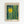 May include: Framed art print displayed on white wall featuring abstract design with bright yellow sun, dark teal and green vertical bamboo-like stalks, scattered polka dots, and foliage elements. Light wooden frame with cream matting against minimalist interior setting.
