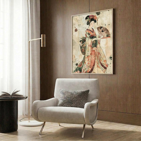 May include: Japanese geisha artwork in ornate kimono holding decorative fan, displayed in modern reading nook with beige upholstered chair, geometric pillow, brass floor lamp, and dark wood wall paneling. Vintage-style print shows woman in flowing robes with traditional hair ornaments against aged cream background with scattered ink spots.